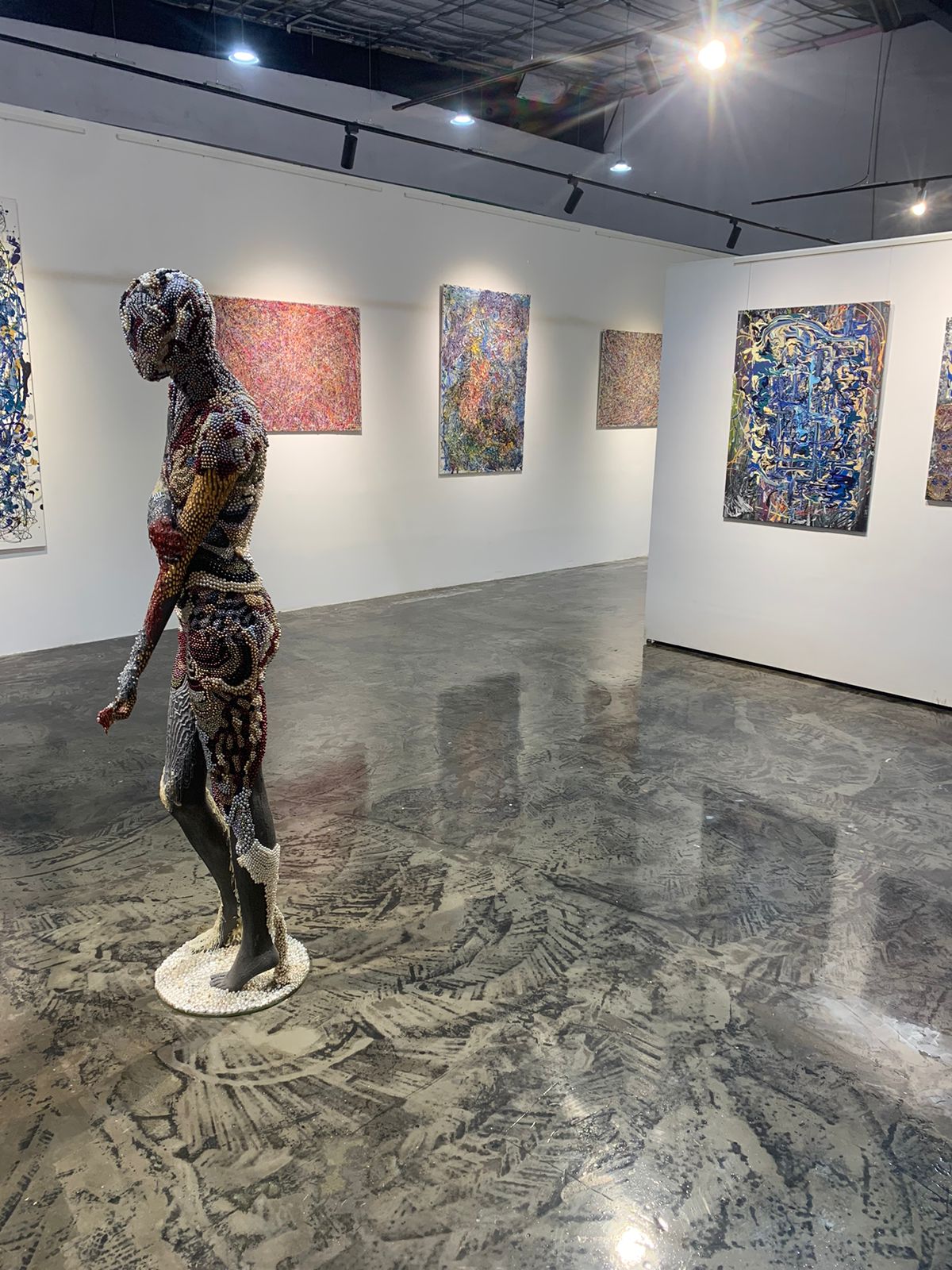 Photo of The Johny Dar Experience art gallery in Dubai showcasing paintings and a sculpture